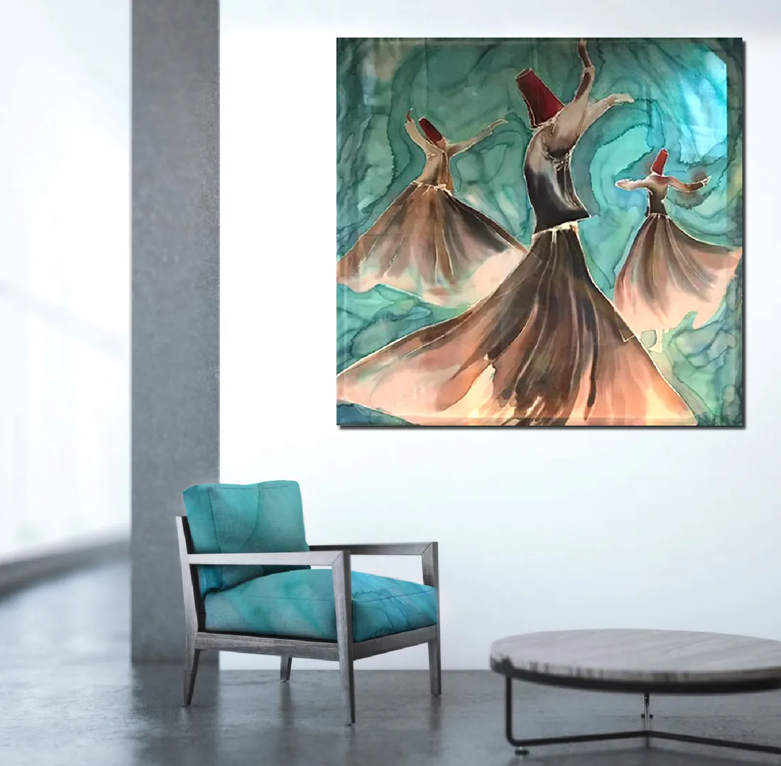 A square painting of three whirling dervishes in tall red hats and flowing brown and peach robes on a turquoise ground, hanging in a bright room above a teal armchair.